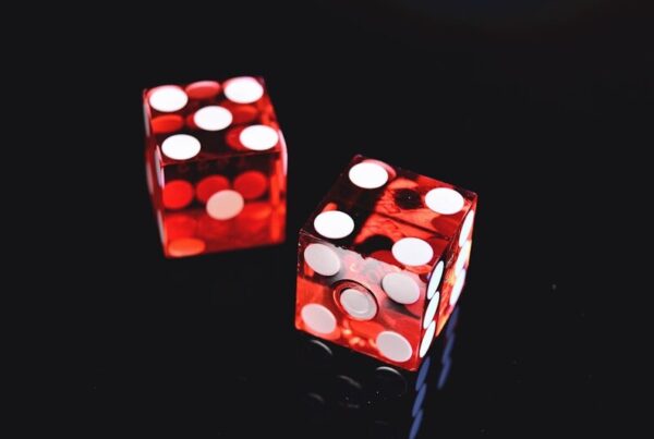 Two red and white dice, representing randomness and chance in on-chain gaming