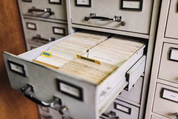 A bank of wooden filing cabinet drawers, representing records held in the custody of the party they are about