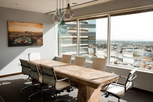 Empty wooden boardroom conference table, representing the investor meetings where product direction is decided