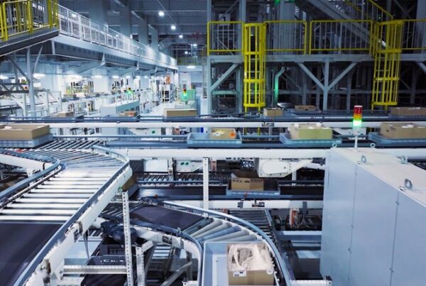 Industrial sorting facility with conveyor machinery and stacked boxes