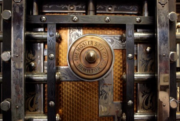 Close up of a heavy metal door with a combination lock