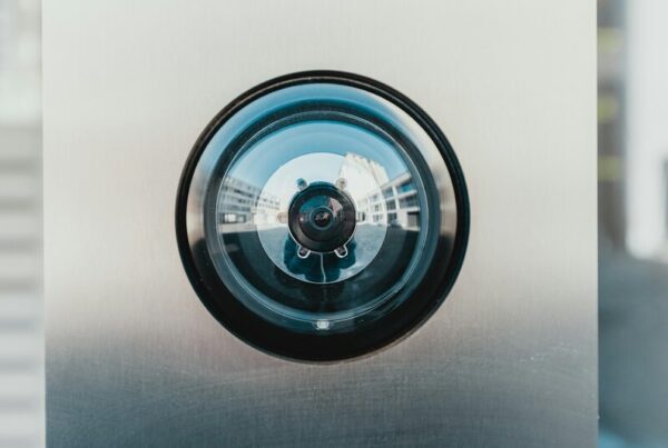Close-up of a dome security camera lens reflecting a building