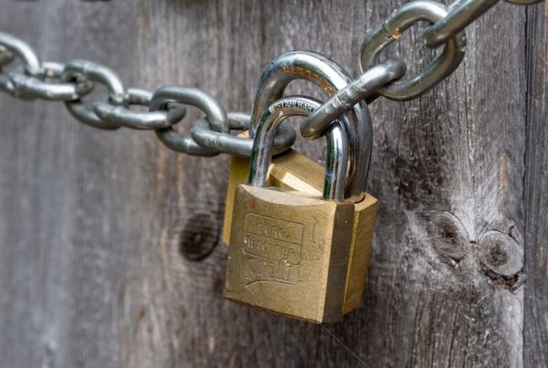 Padlock on a wooden fence, illustrating issuer control over frozen stablecoin balances