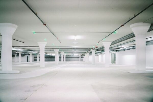 An empty concrete multi-storey car park with pillars and unused parking bays